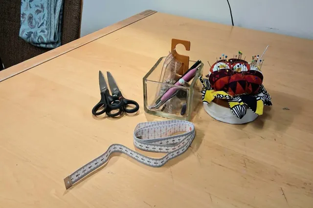 Open sewing workshop, volunteer facilitator present